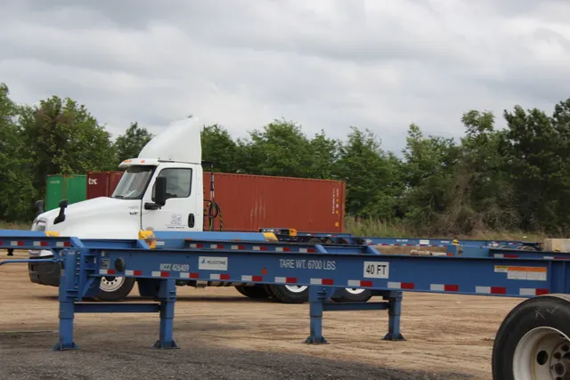 Empty 40-foot chassis staged with stacked containers in the background at the Savannah yard, 2024